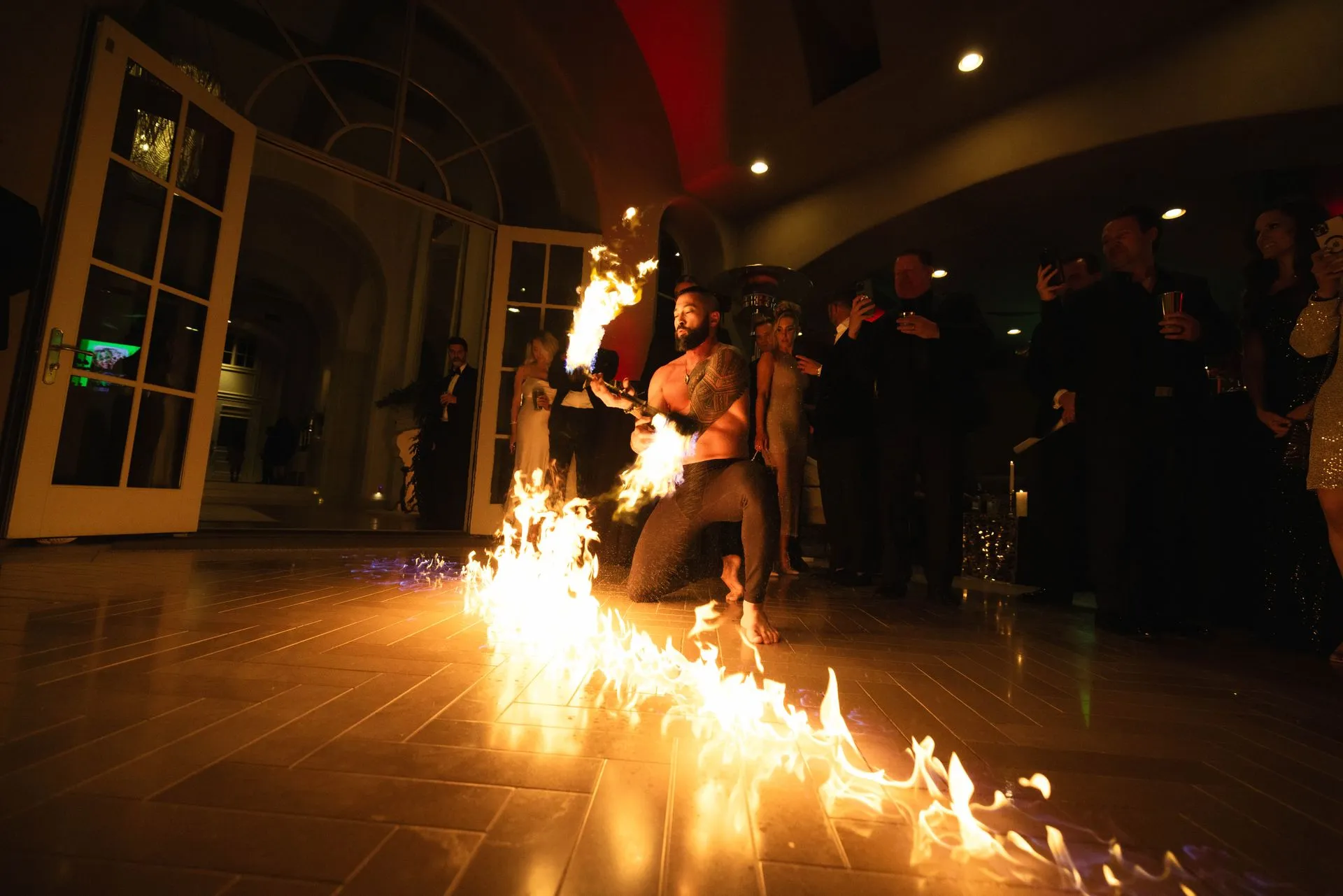 A man is holding a torch in front of a crowd of people.
