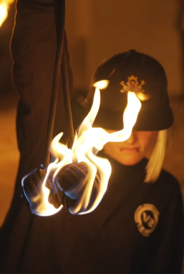 A person holding a torch with a skull and crossbones on it