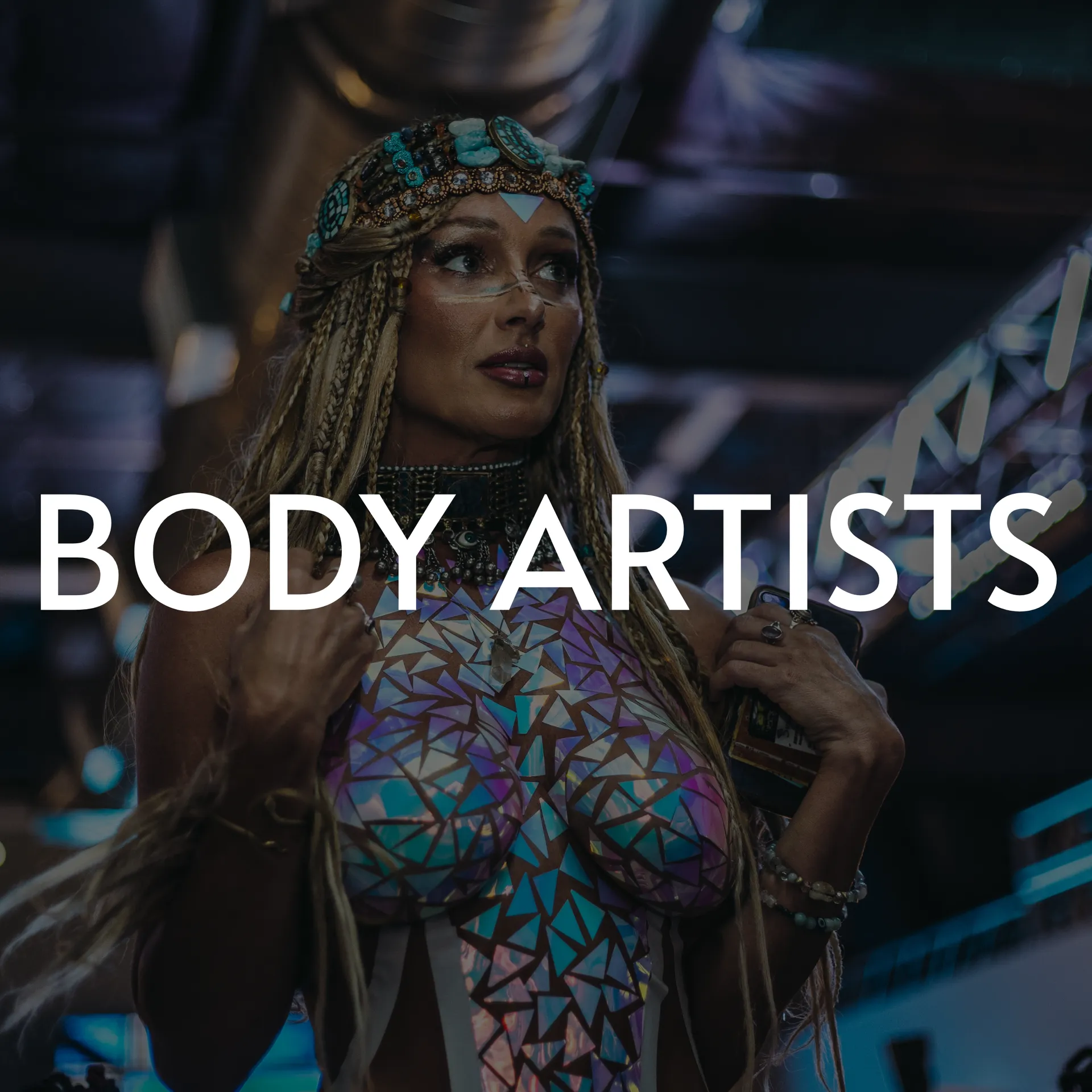 Woman in body paint, ornate headpiece. Text overlay: BODY ARTISTS.