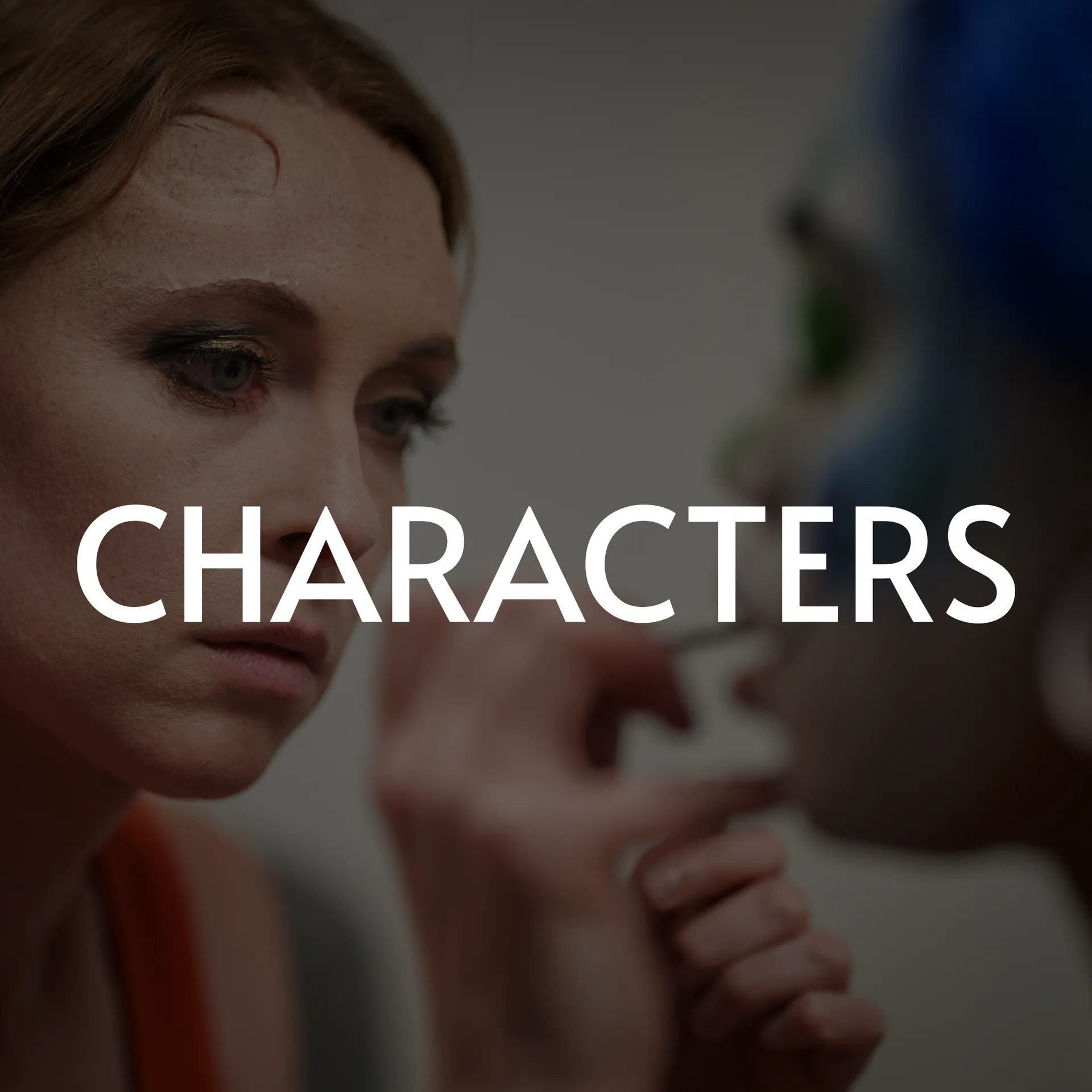 A woman applying makeup to another person with blue hair; the word