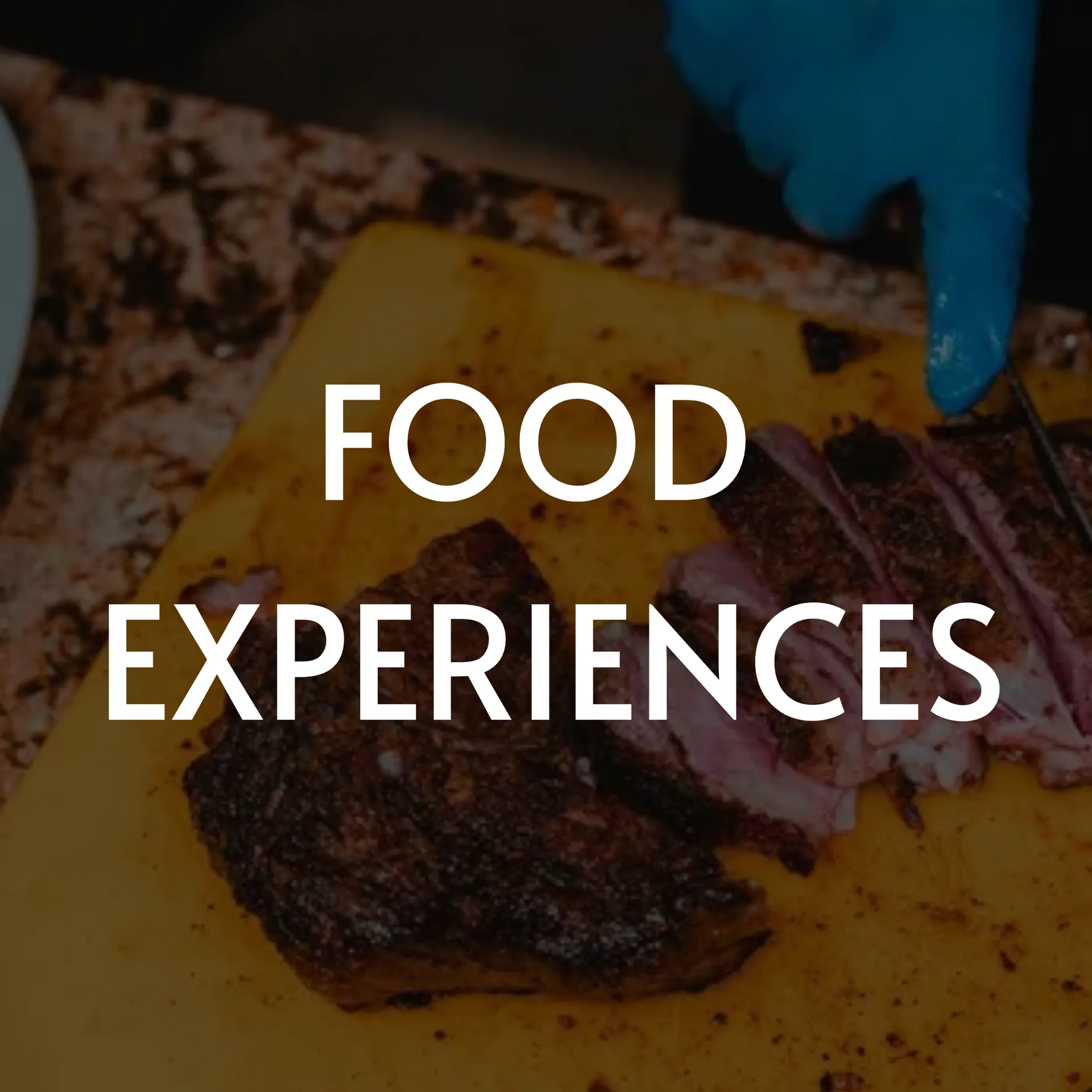 Food Experiences: Person slicing smoked meat on yellow cutting board.
