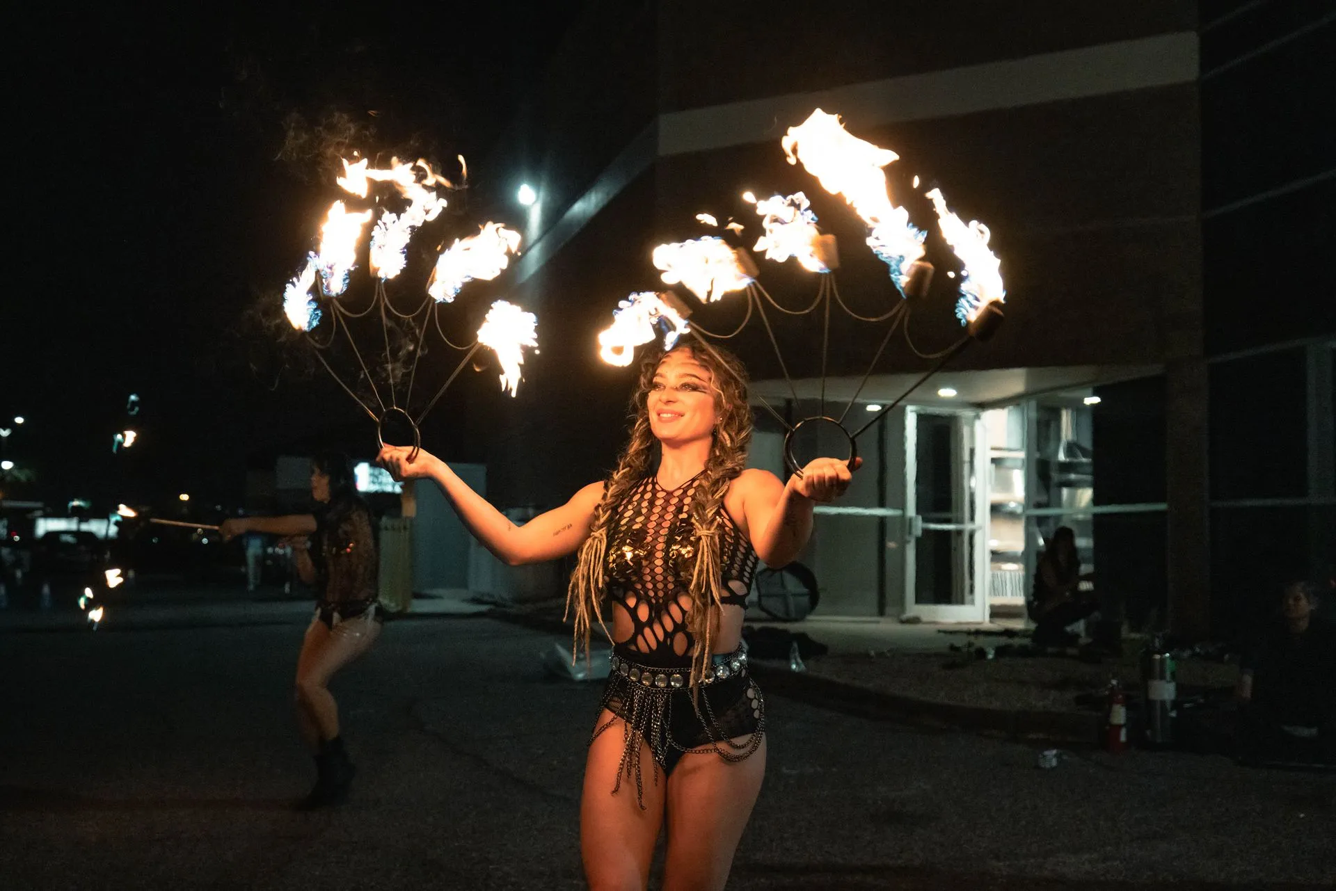 A woman is holding a bunch of fire in her hands.