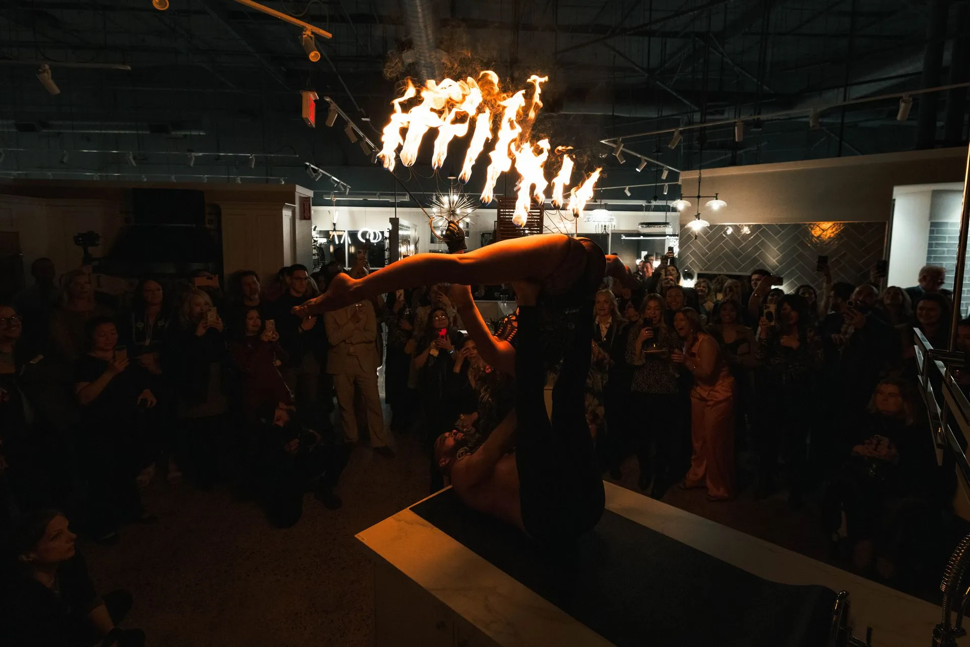 A man is performing a fire show in front of a crowd.