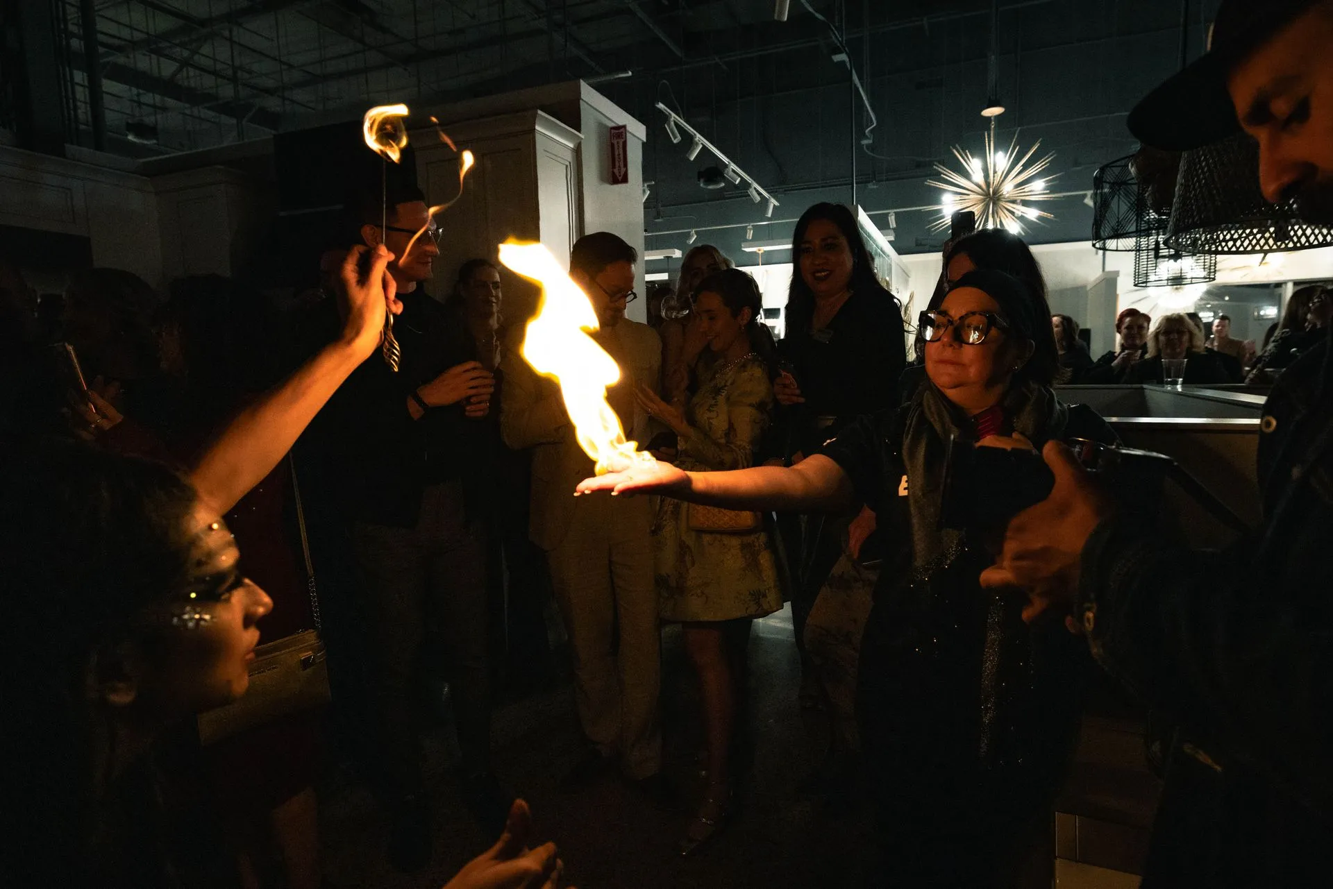 A group of people are standing around a person holding a torch.