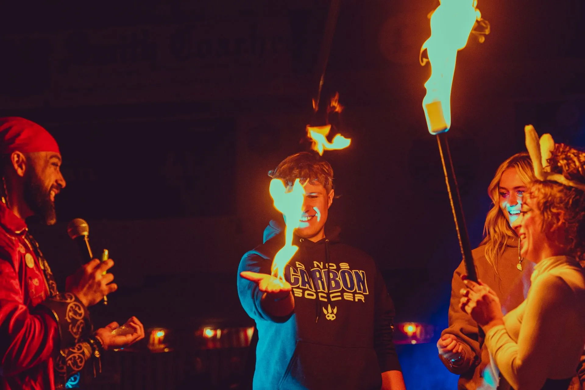 A man is holding a torch in front of a group of people.