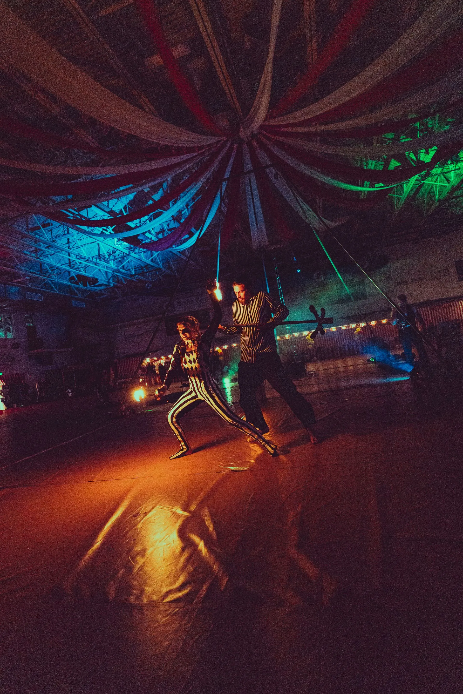 A couple of people are dancing in a dark room.