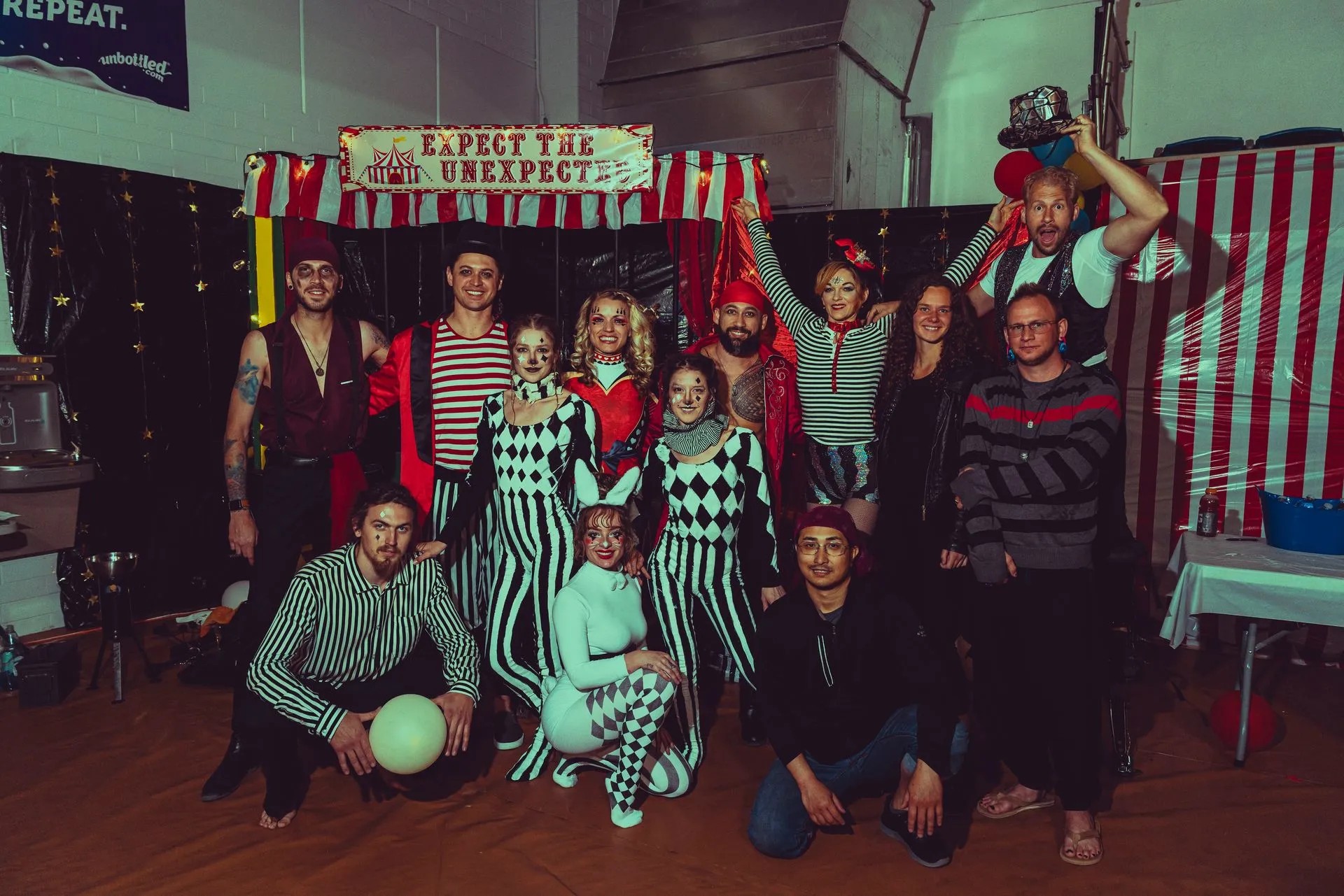 A group of people are posing for a picture in a room.