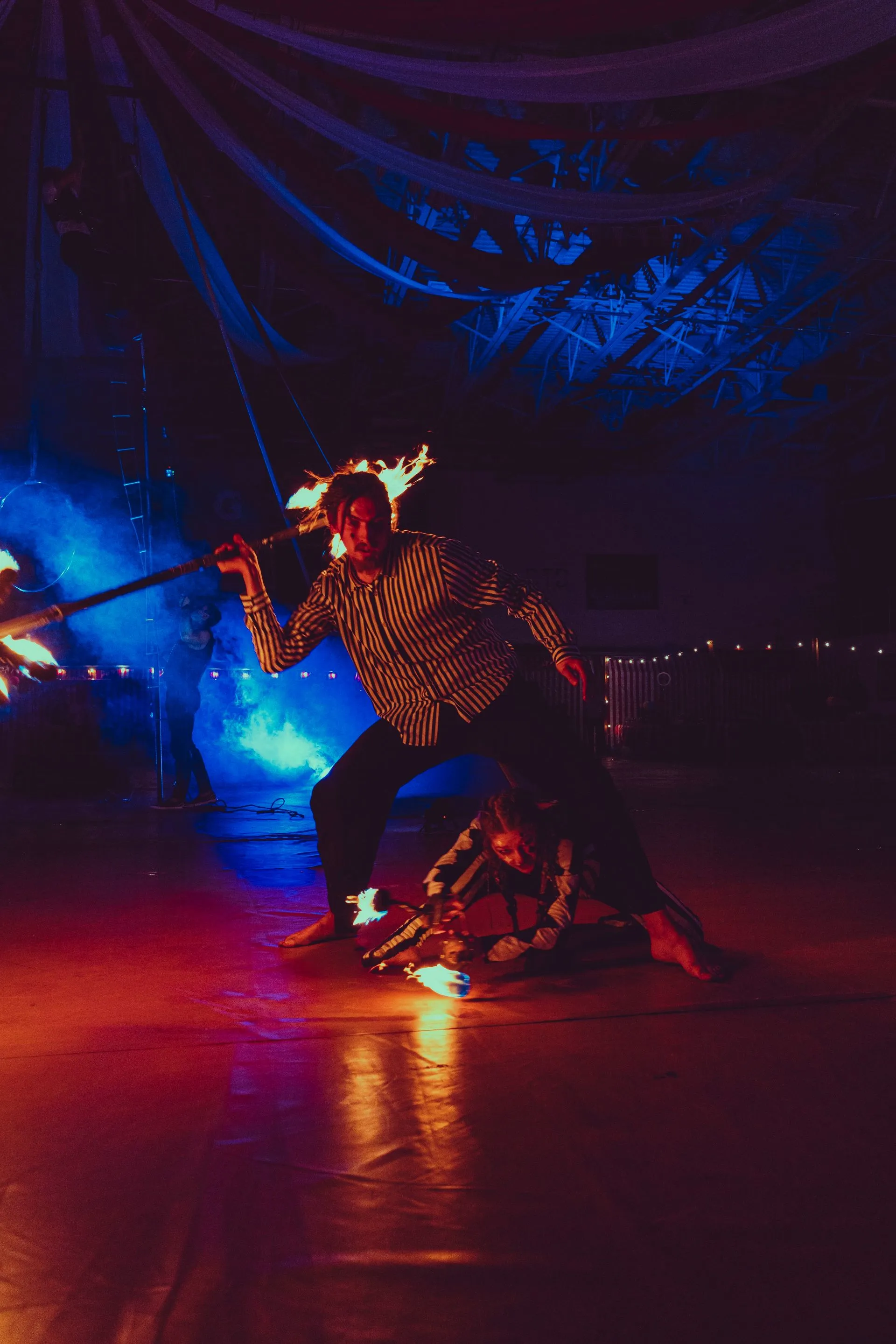 A man and a woman performing with fire.