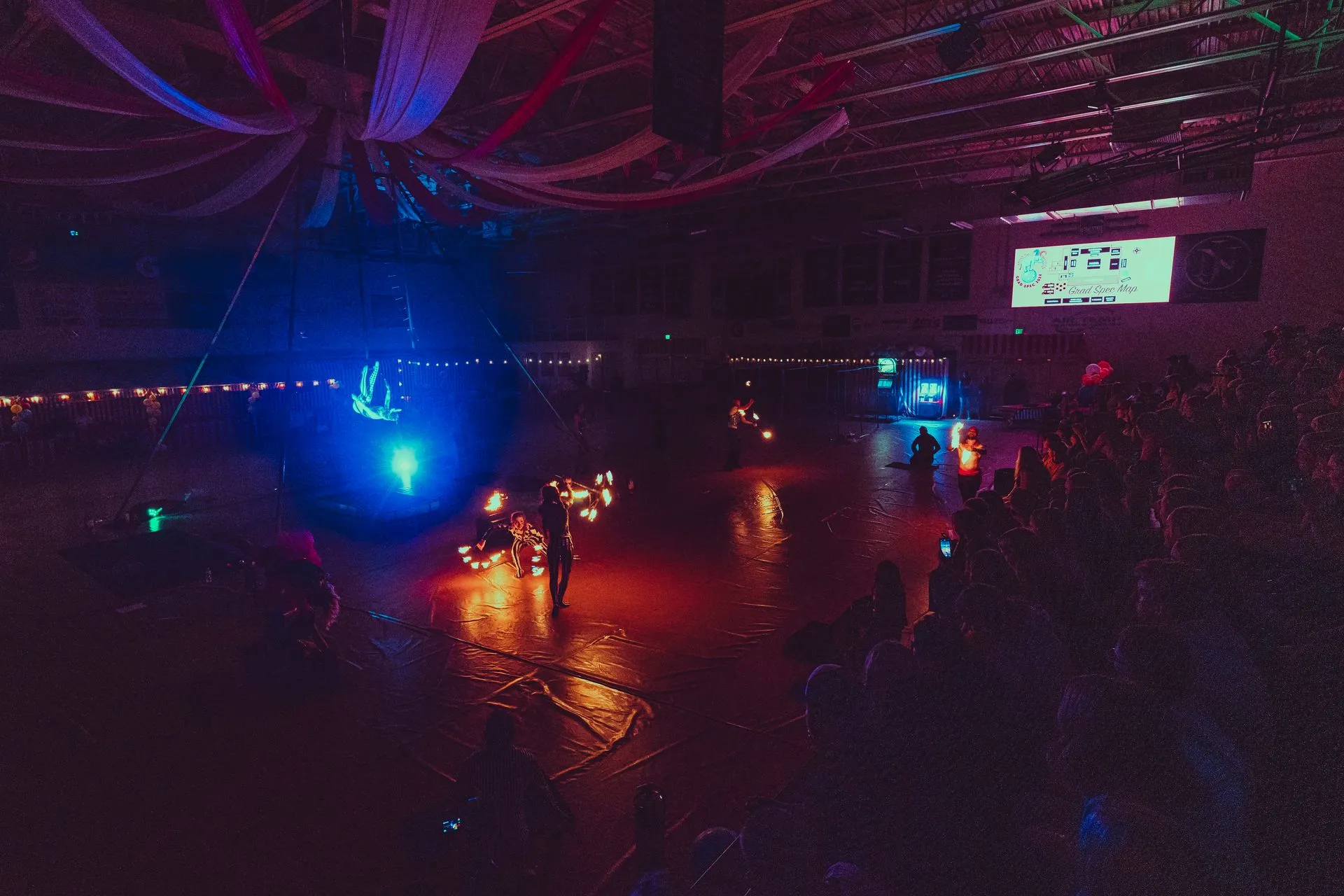 A group of people are standing in a dark room with a lot of lights.