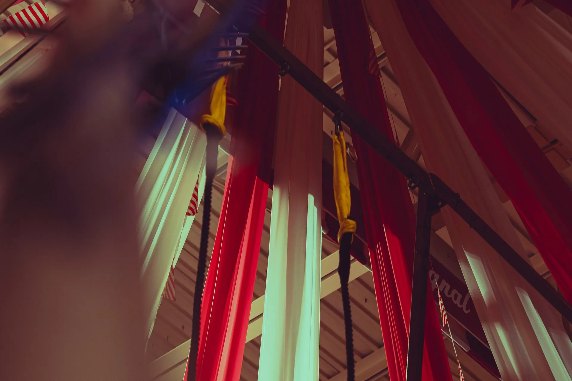 A bunch of red and white pipes are hanging from the ceiling