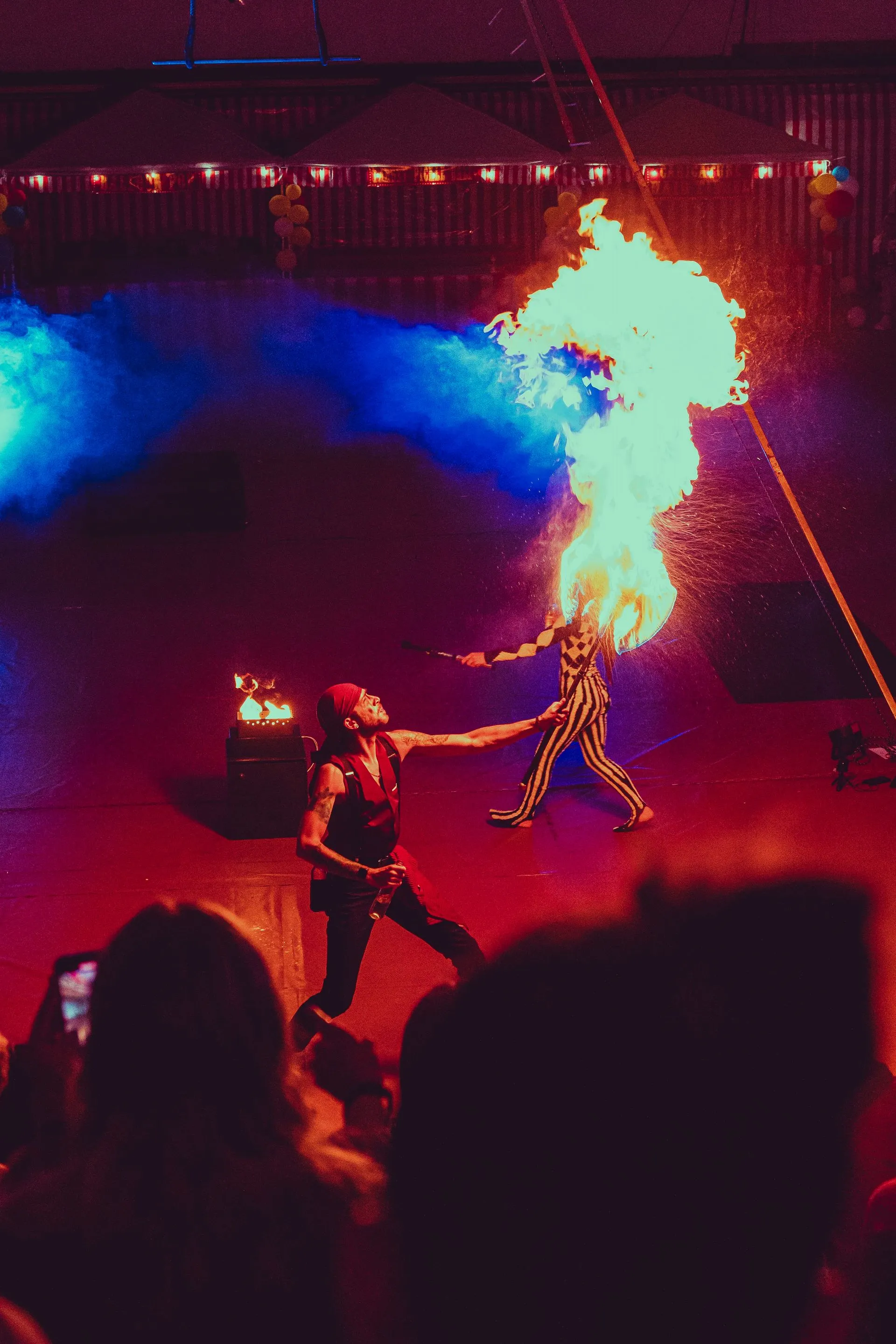 A group of people are watching a fire show.