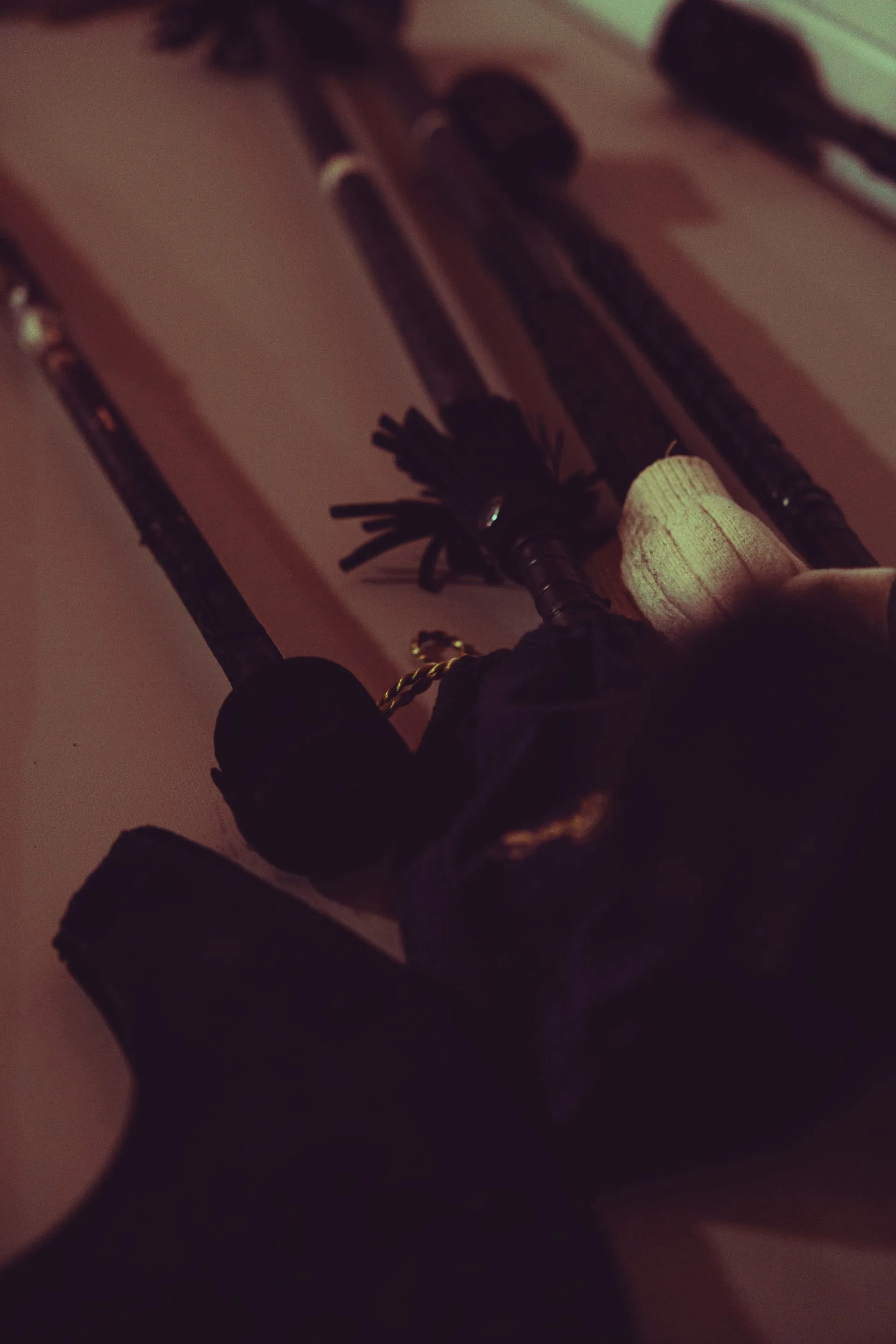 A person is holding a black object in their hand