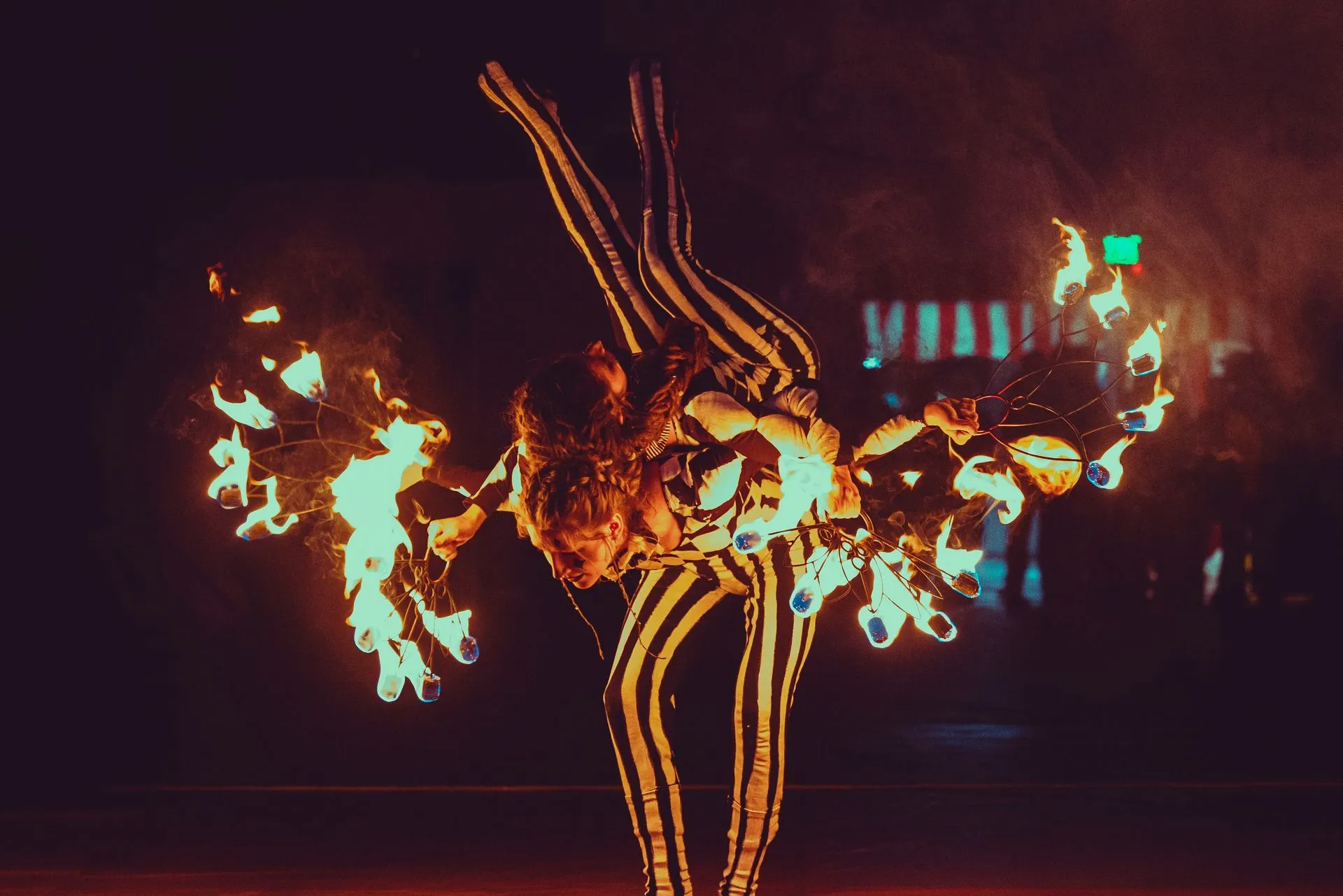 A group of people are performing a fire show at night.