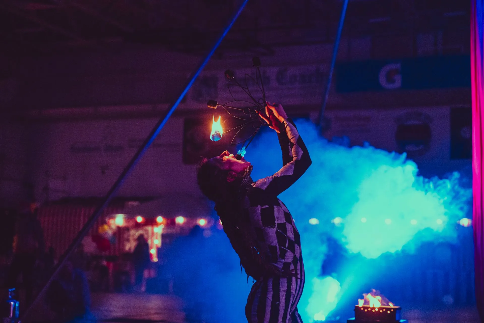 A man is juggling fire in his mouth.