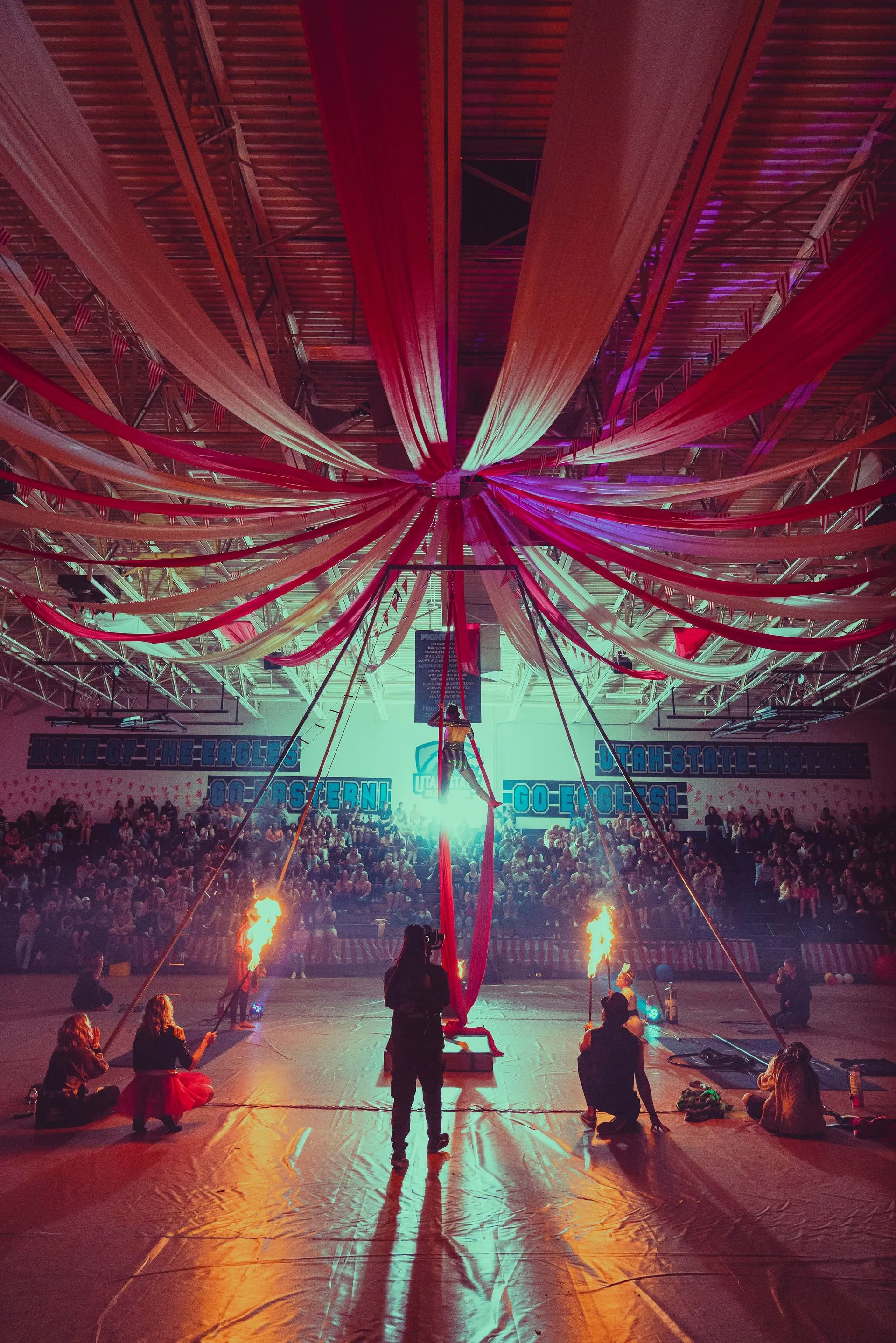A group of people are standing on a stage in a stadium.