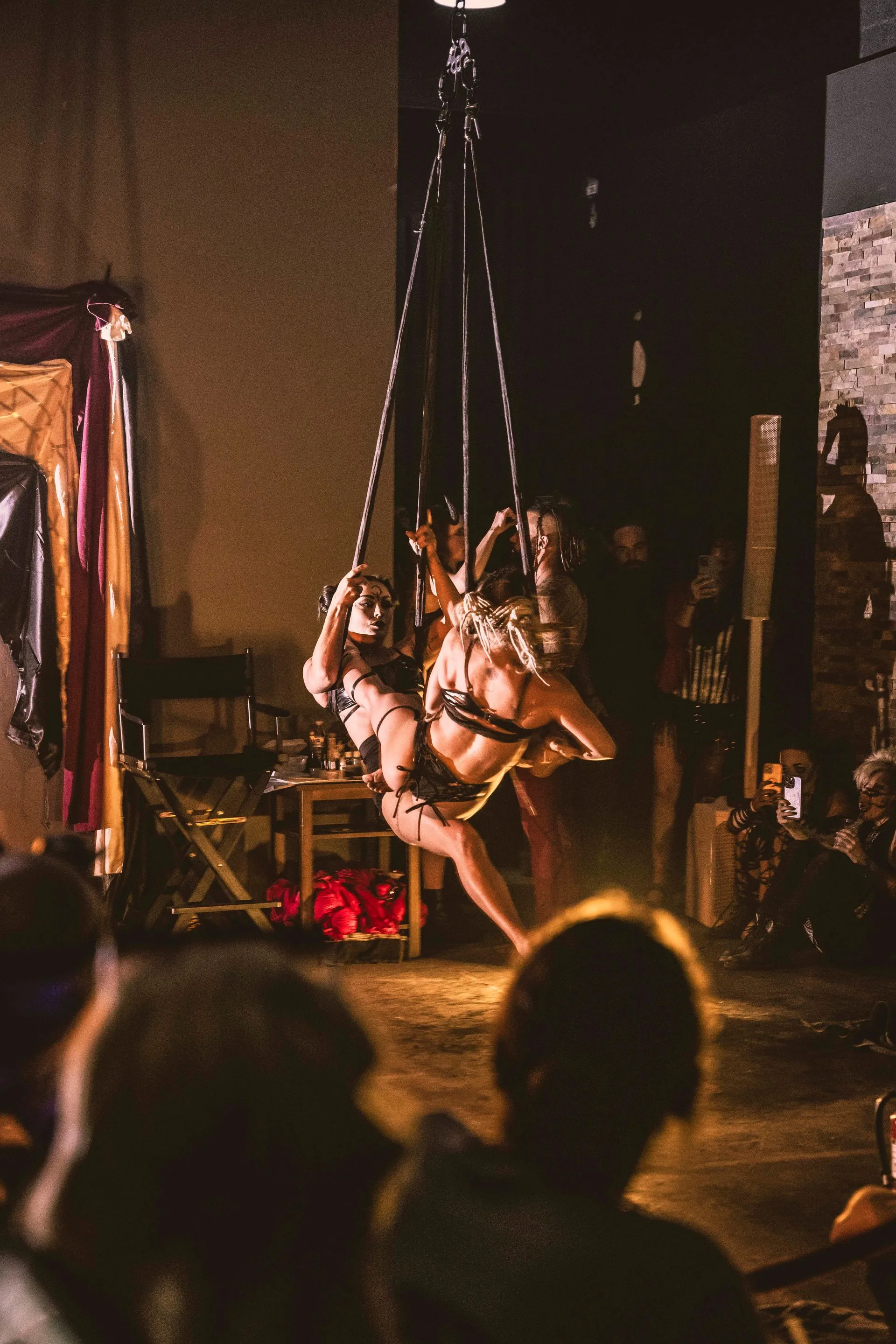Two women performing on duo straps.