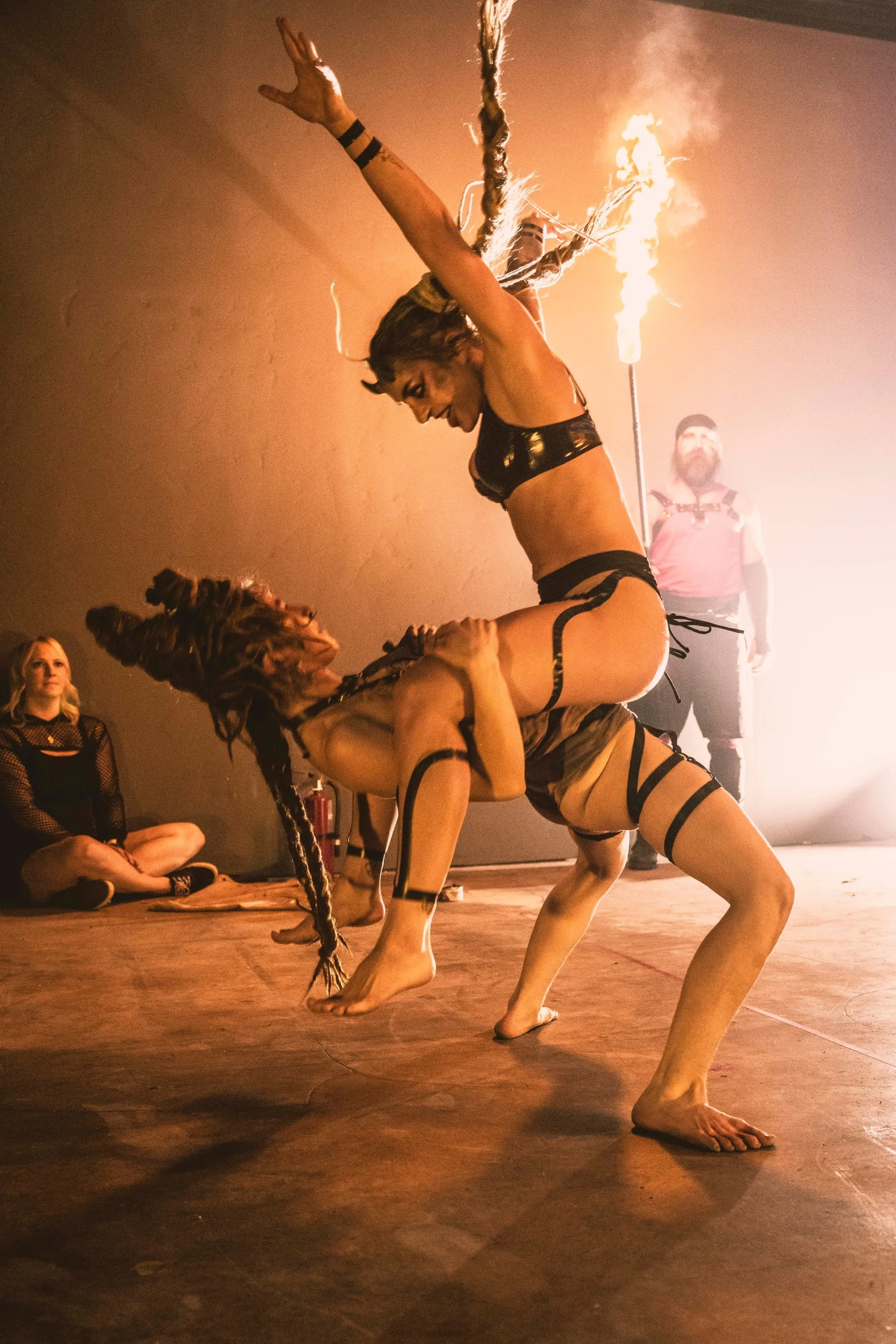 Two women performing acrobatics together in a show.