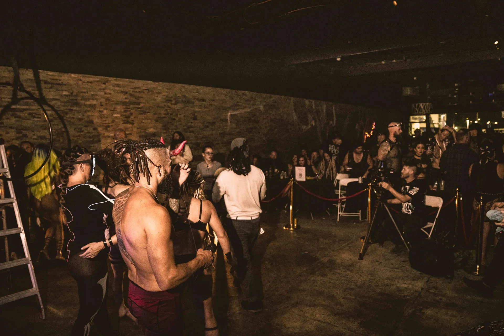 A group of people are standing in a dark room.