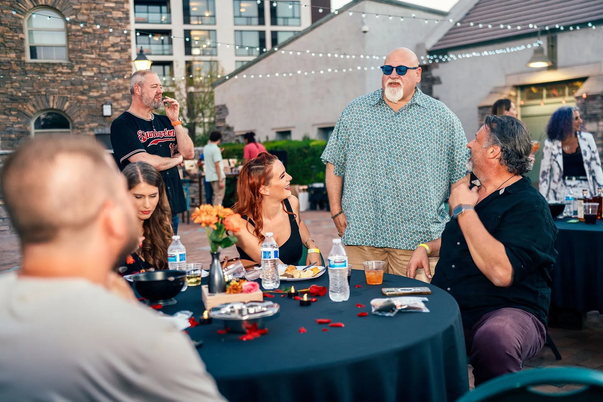 A group of people are sitting at a table talking to each other.