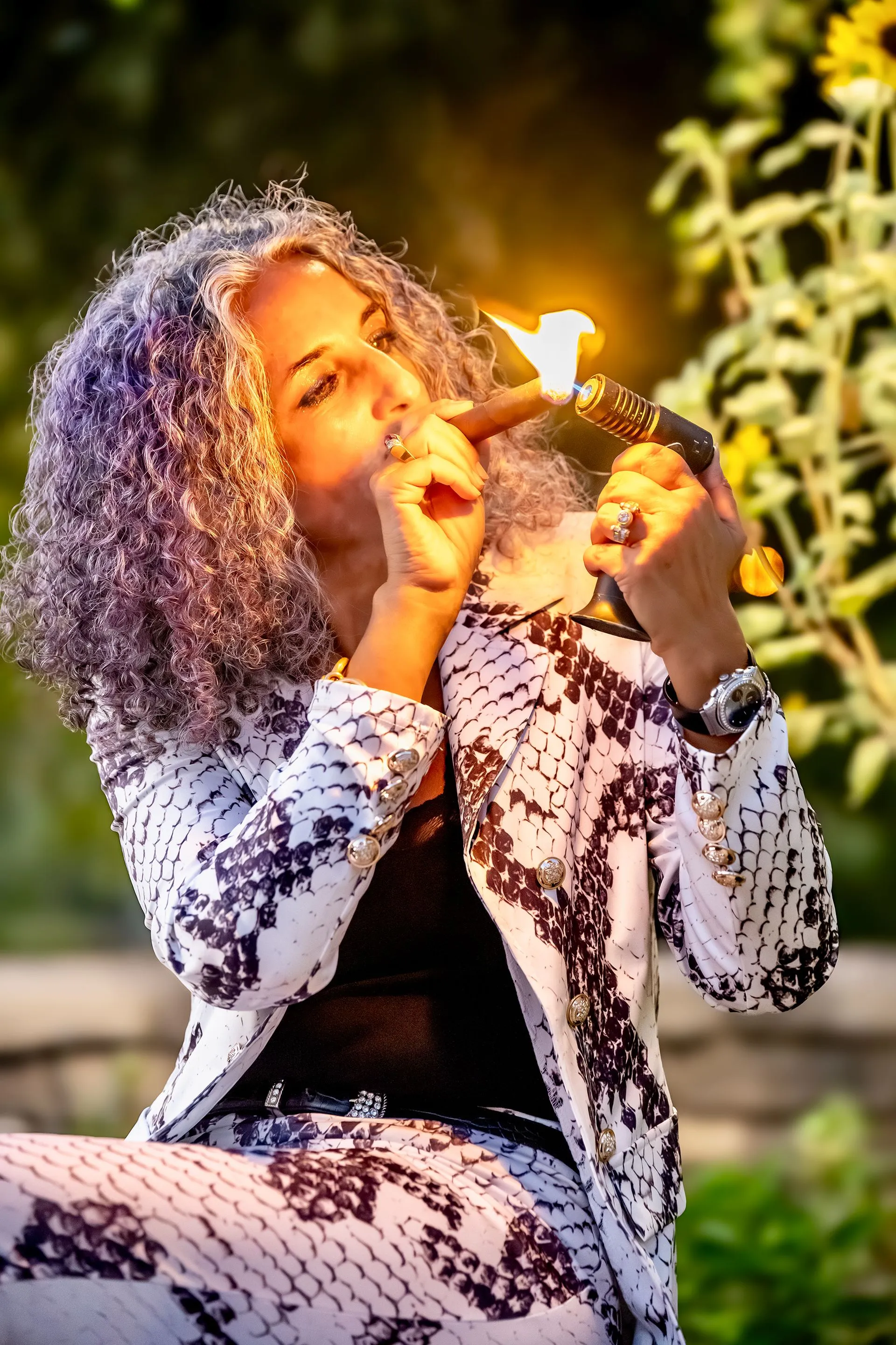A woman lighting a cigar.