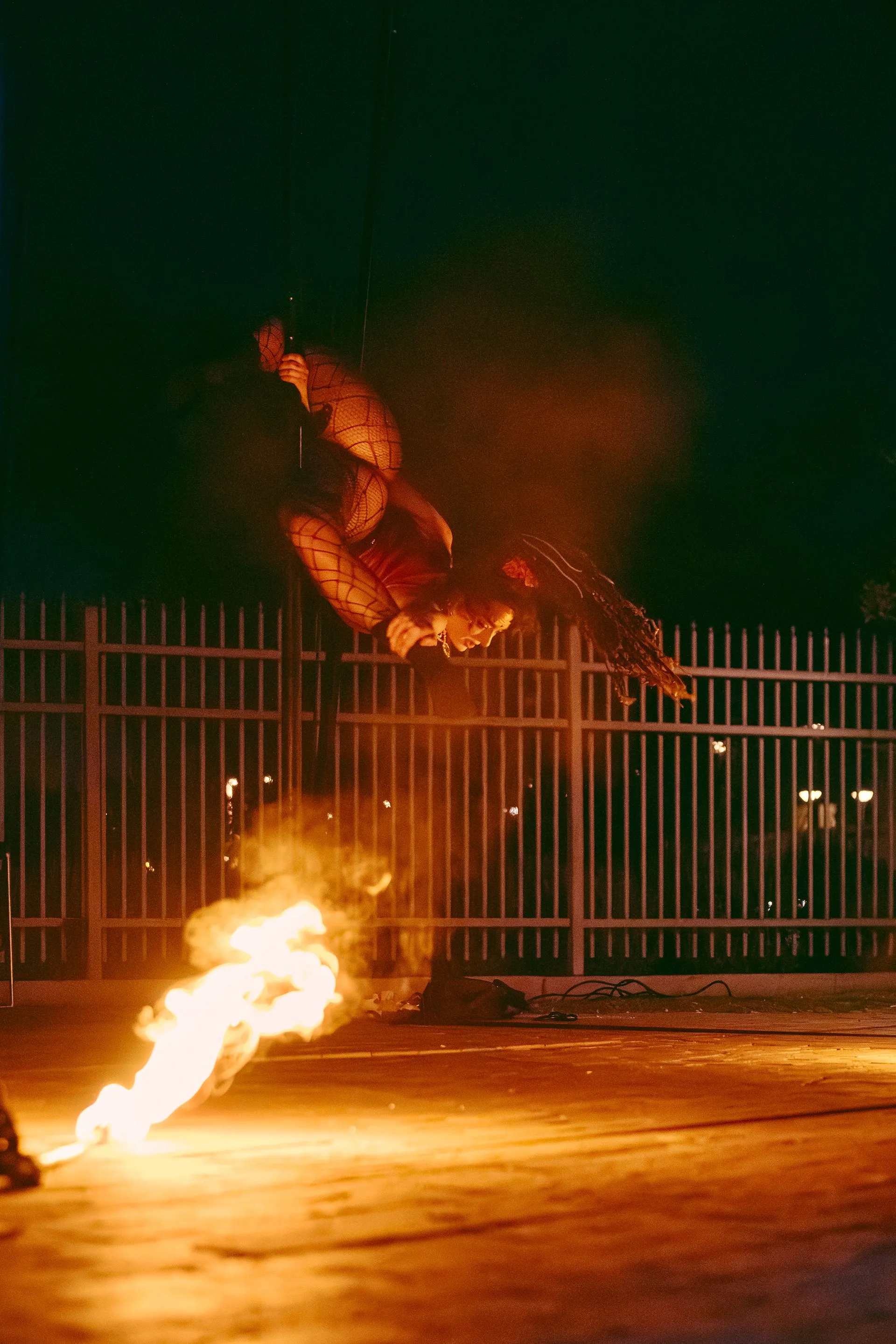 A person is doing a trick on a skateboard with flames coming out of it.