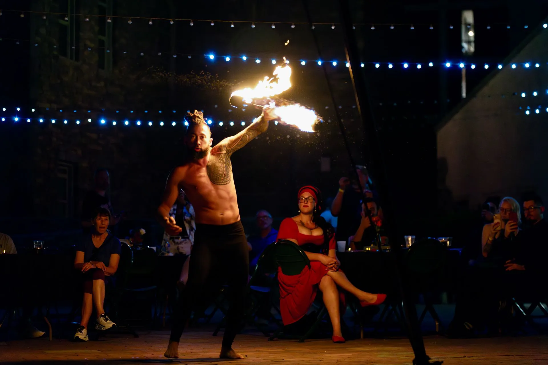 A fire performer entertaining a crowd.