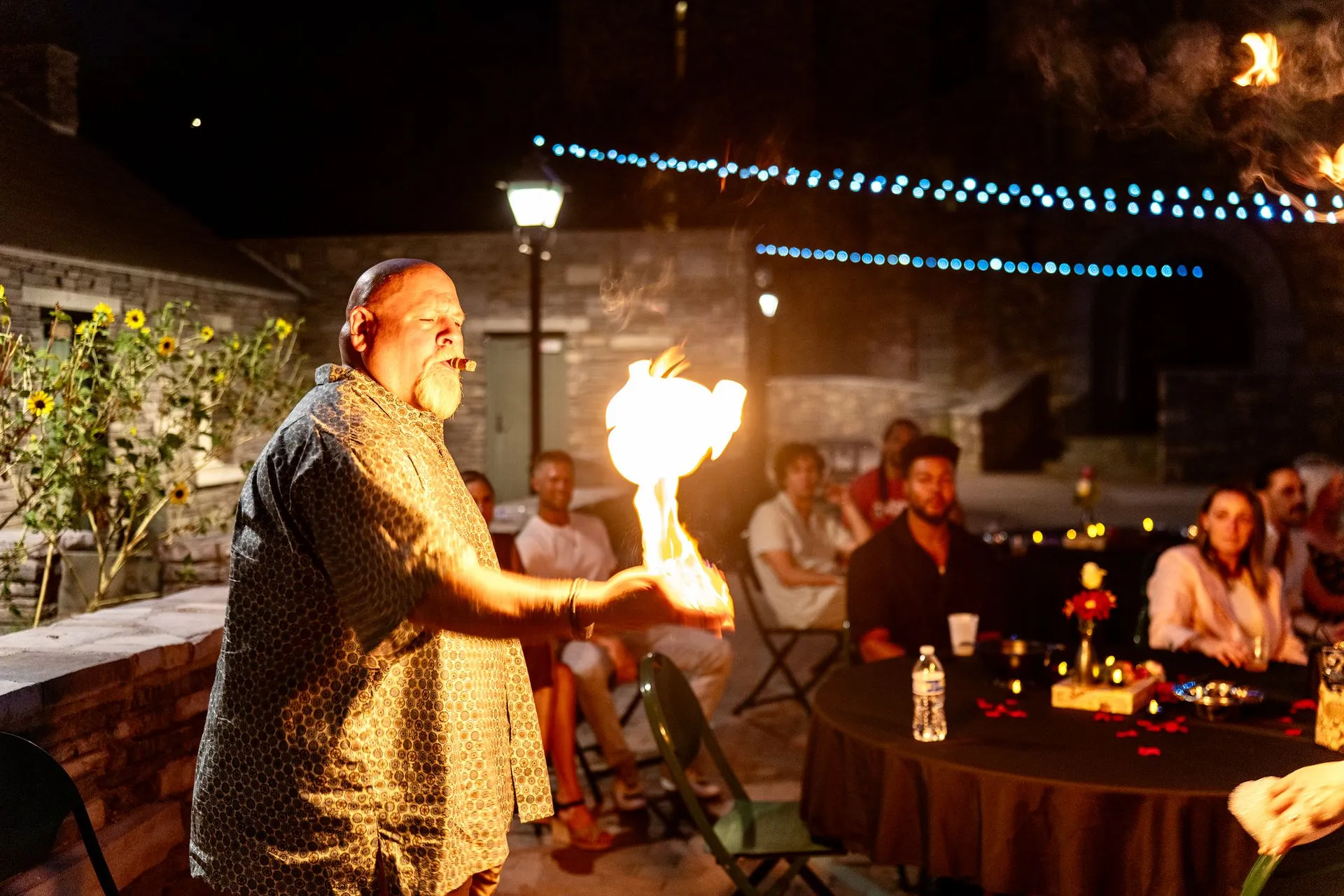 A man is holding a torch in front of a group of people