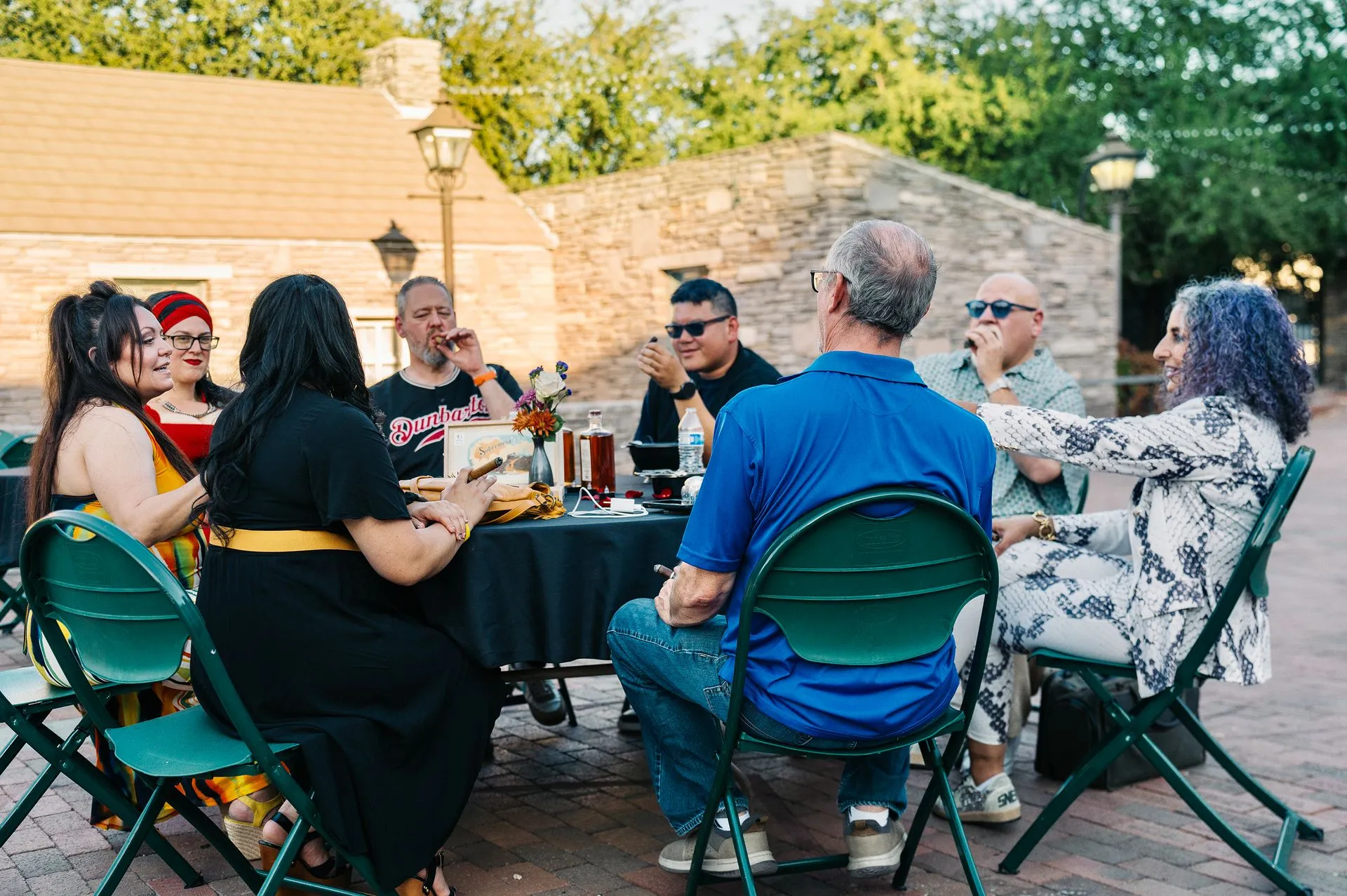 A group of people are sitting around a table eating food.