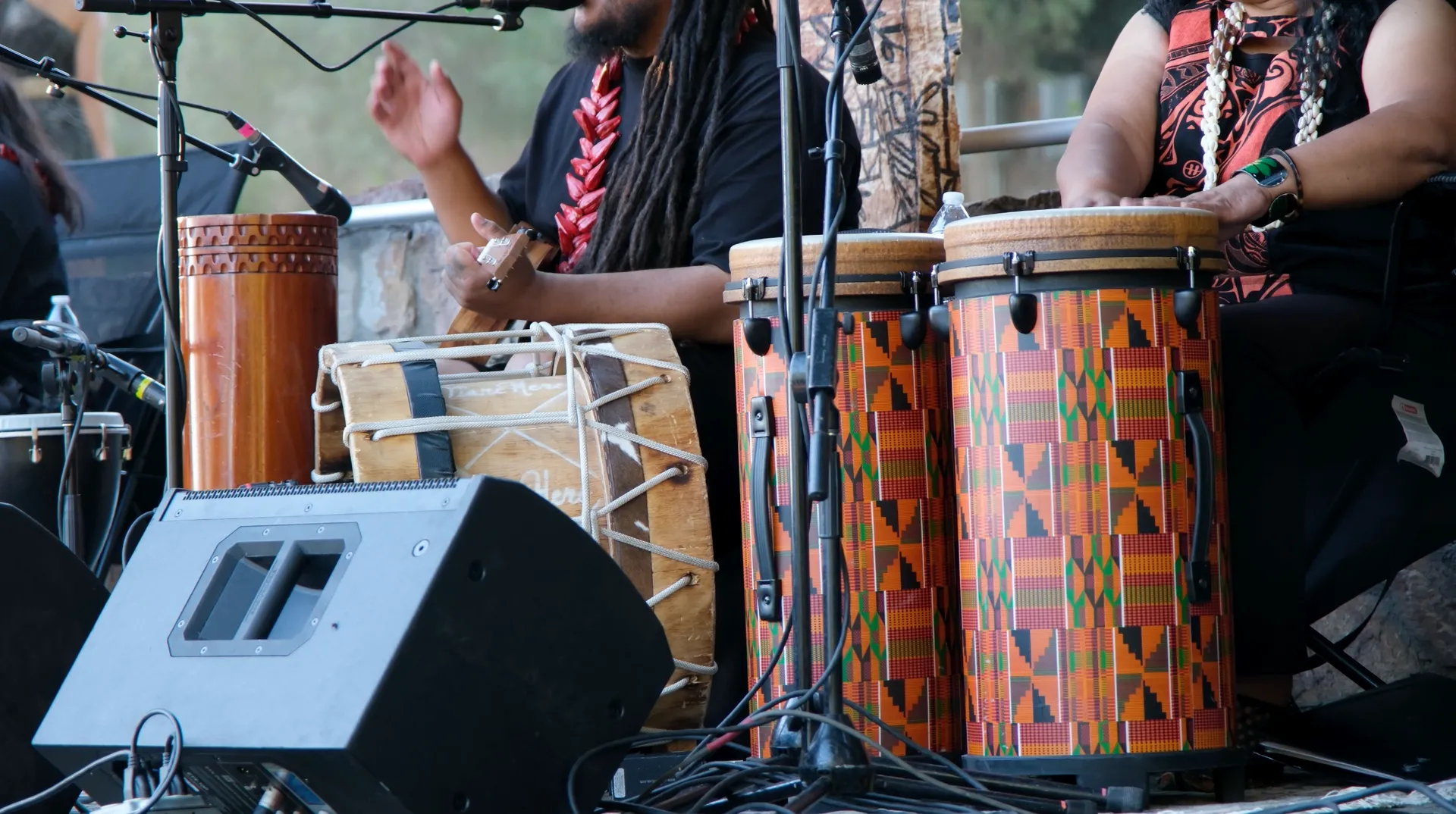 A group of people are playing drums on a stage.