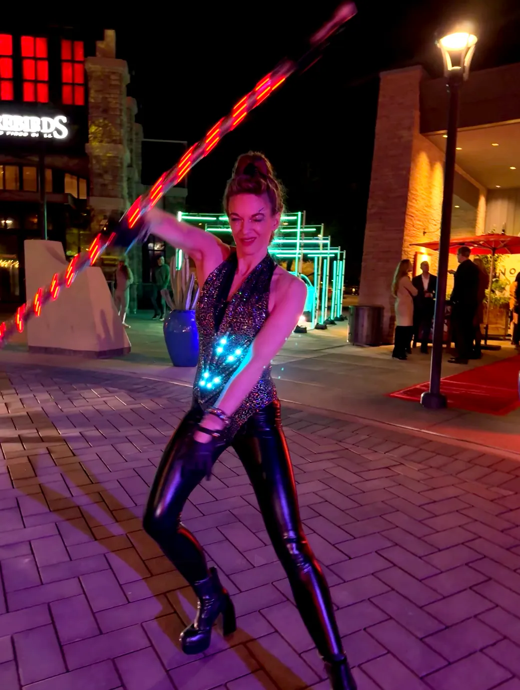 A woman is holding a hula hoop in front of a mcdonald 's restaurant.
