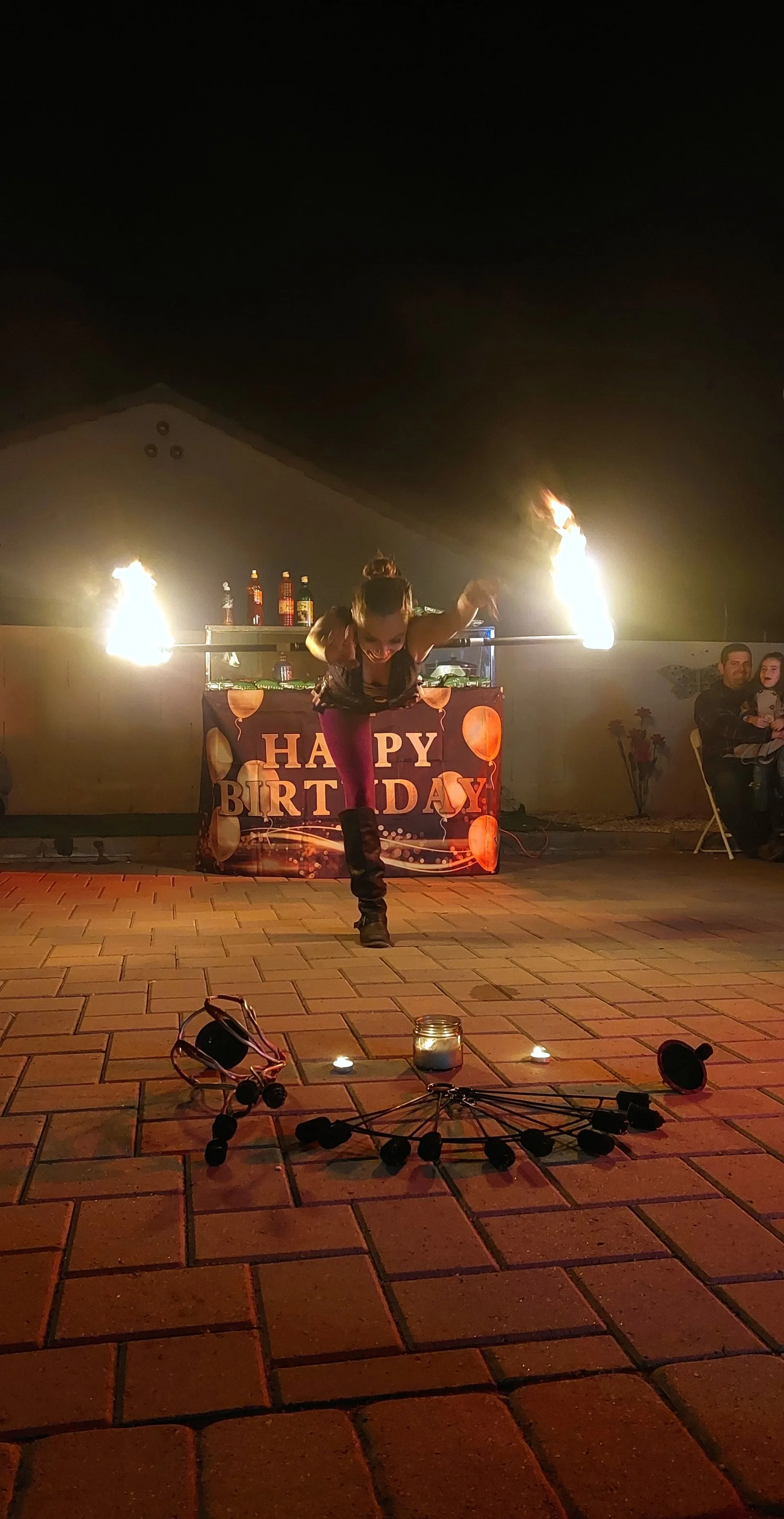 A person is standing in front of a sign that says happy birthday.