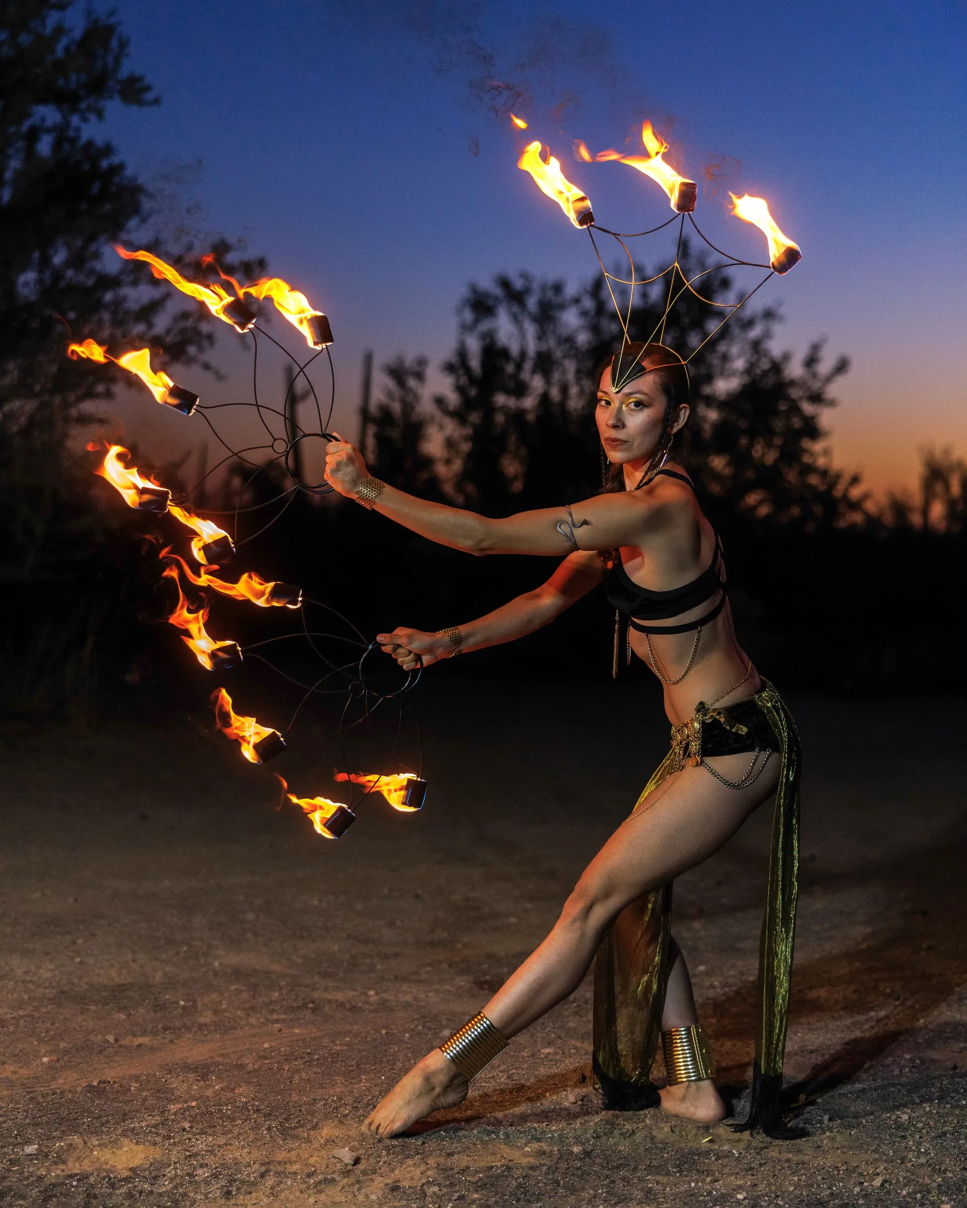 A woman is holding a hoop of fire in her hands