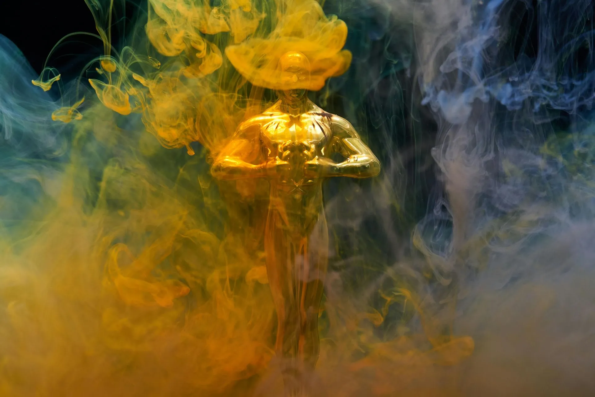 Statue engulfed in yellow and blue swirling ink.